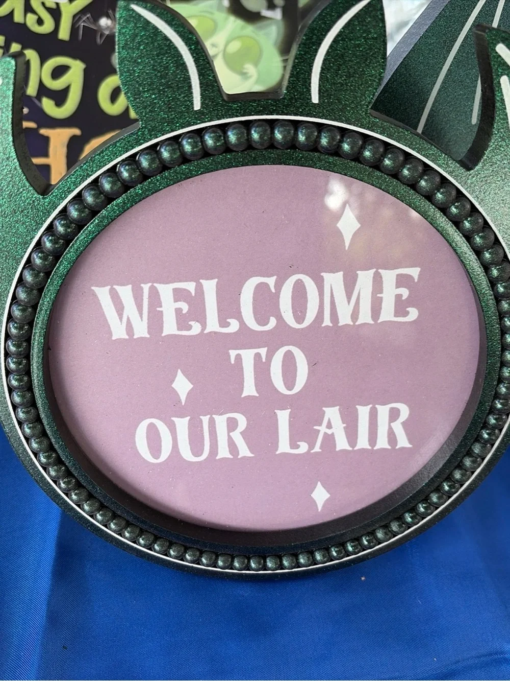 Welcome to Our Lair Decorative Sign - Green Frame, Pink Insert